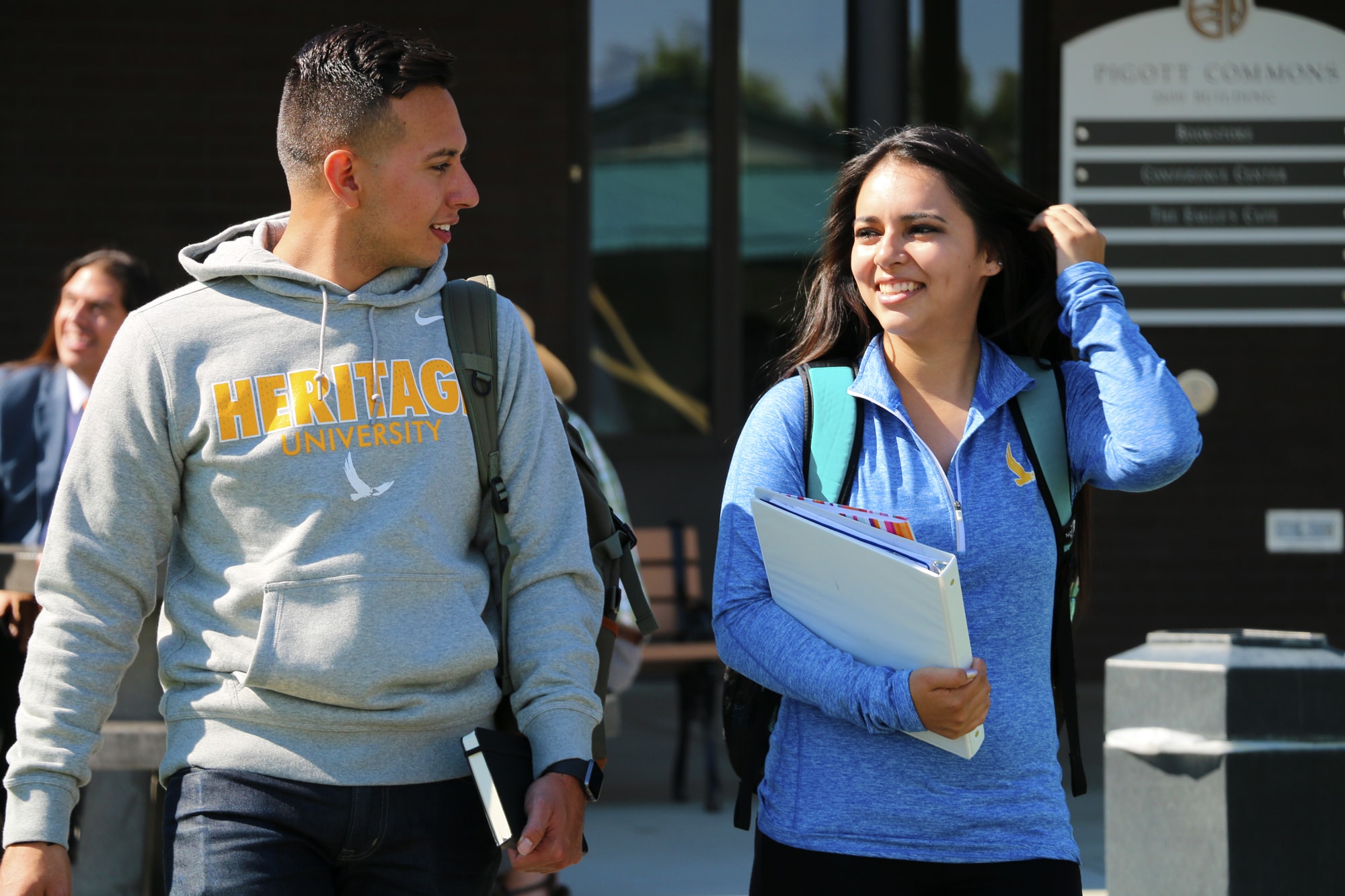 Male and Female Students Walking On Campus