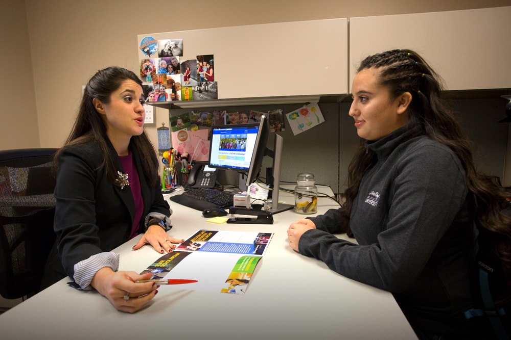 Student counselor with student at Heritage office