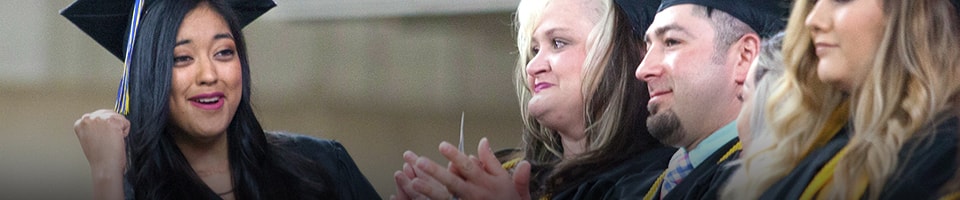 Student happy cheering during graduation ceremony at heritage university