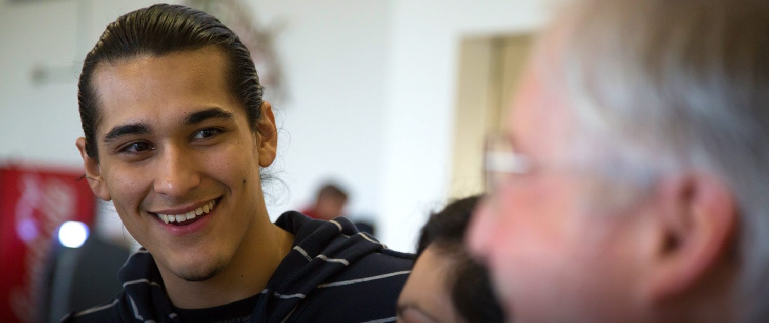 Student smiling at faculty at Heritage university