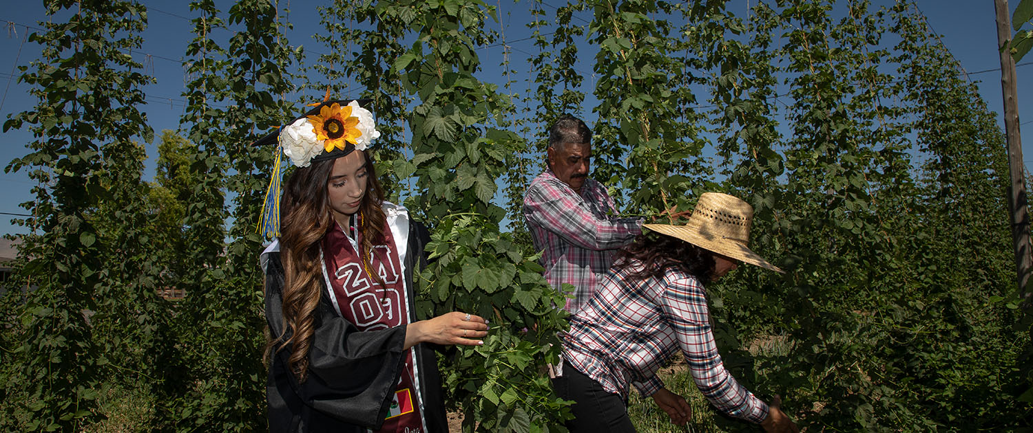 Maria and parents in hops field