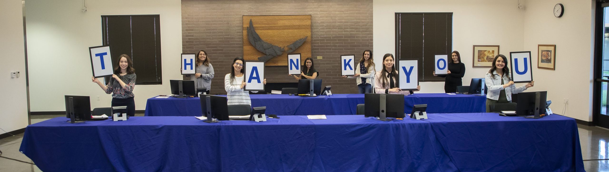 Student phone operators holding Thank You Sign